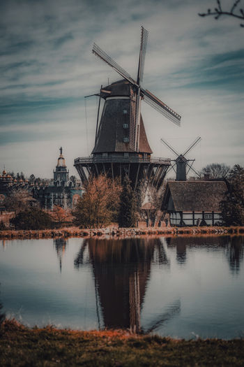 Historic windmills in front of a lake in springtime