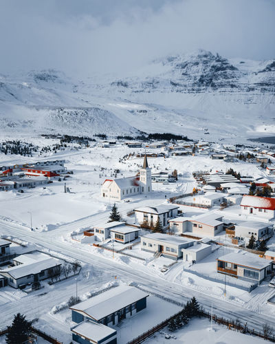 High angle view of snow covered buildings in city