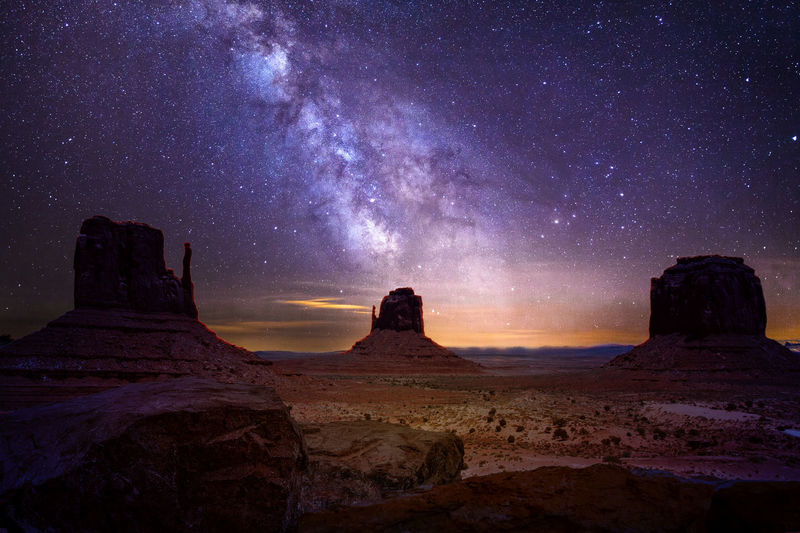 Scenic view of rock formation against sky at night