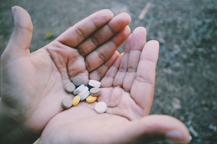 Cropped image of hands with medicines