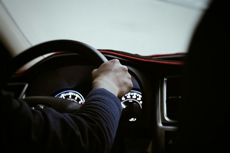 Cropped image of man driving car