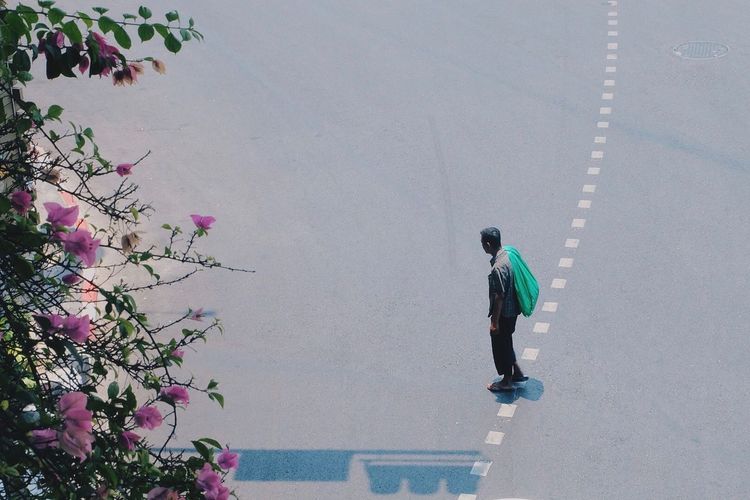 High angle view of man standing on street