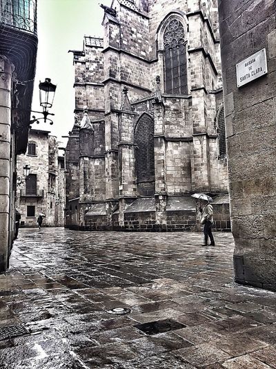 Rear view of woman walking on old building