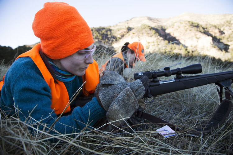Two female hunters ready their rifles to shoot elk in colorado