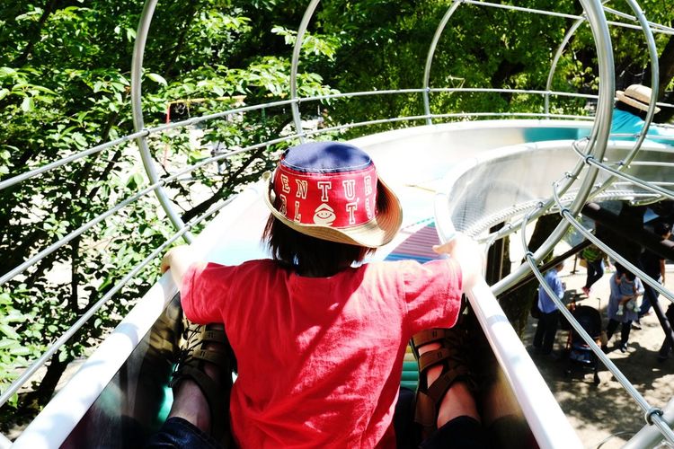Rear view of boy on slide