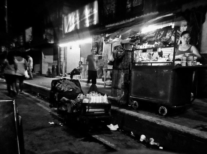 Man working on street in city at night