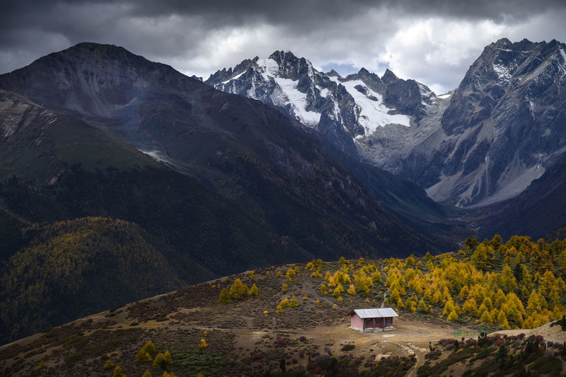 Scenic view of mountains against cloudy sky