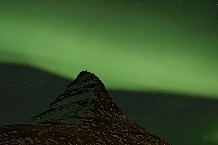 Low angle view of aurora borealis at night during winter