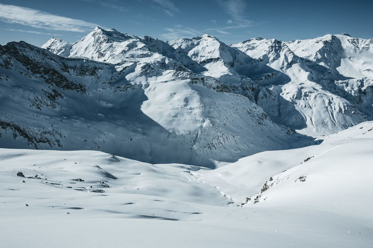 Scenic view of snowcapped mountains against sky