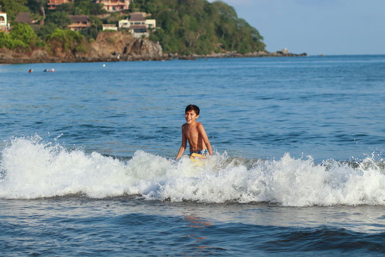 Full length of shirtless man in sea