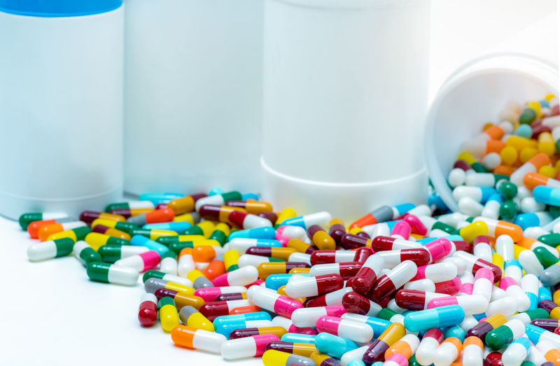 Heap of antibiotic capsule with plastic bottle. antibiotic drug resistance concept. antibiotic drugs
