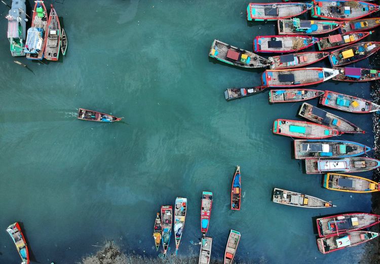 High angle view of boats moored in sea at harbor