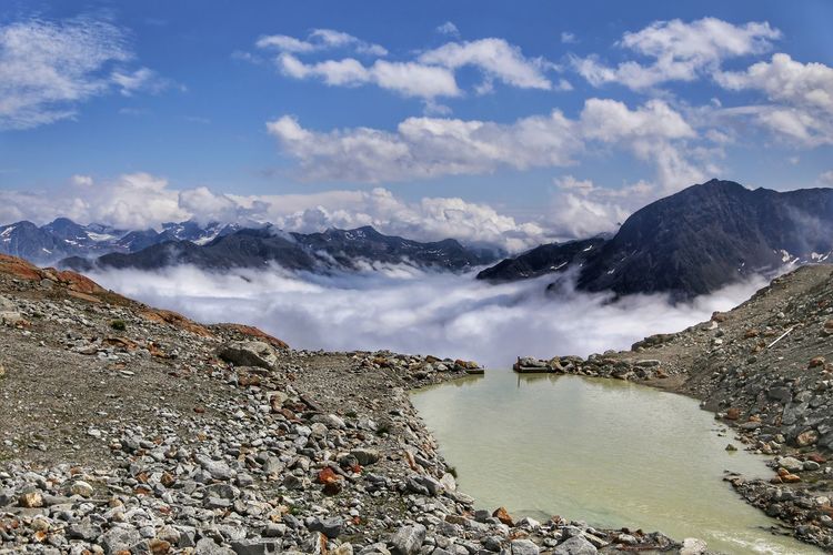 Scenic view of lake and mountains against sky