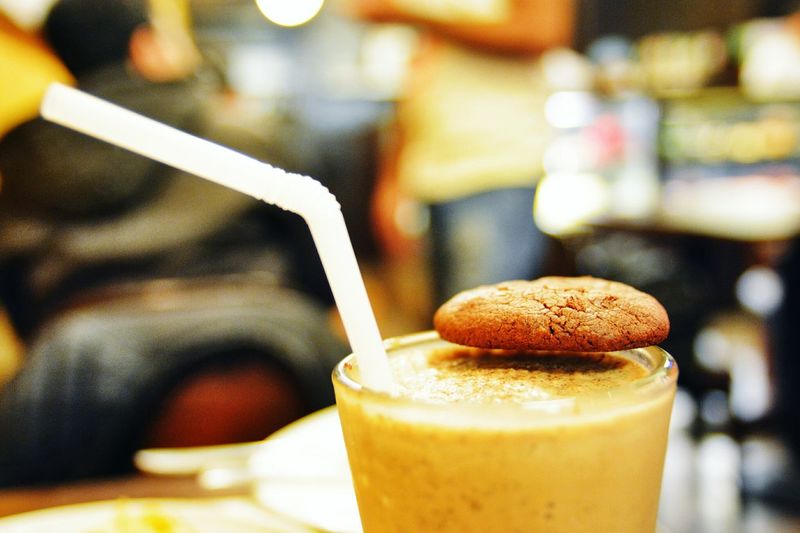 Close-up of chocolate milkshake with cookie garnished with cookie on table