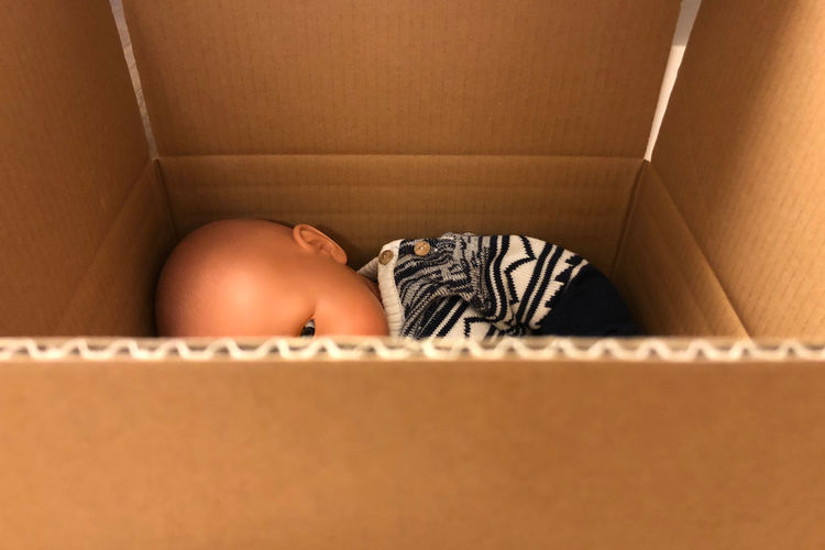 Boy sleeping in box