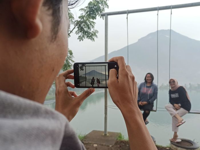 Man photographing through mobile phone
