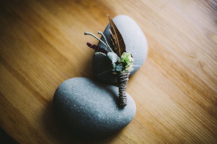 Close-up of small bouquet and pebbles on table