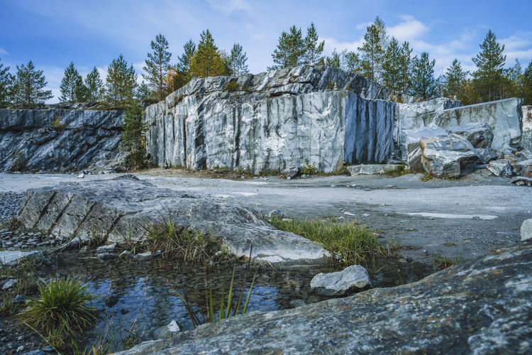 Italian quarry with smooth sections of marble in the ruskeala mountain park on a sunny summer day