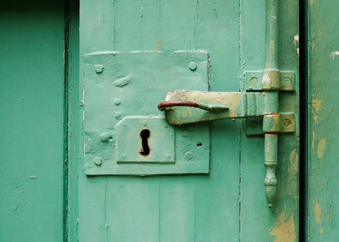 Full frame shot of green door with old latch