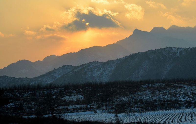 Scenic view of mountains against sky during sunset