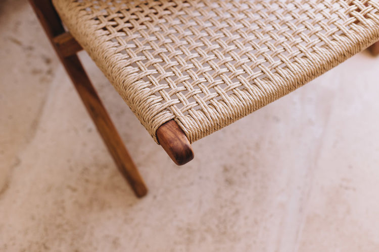 Close up of a woven seat against a textured background