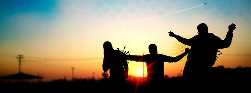 Silhouette people on field at sunset