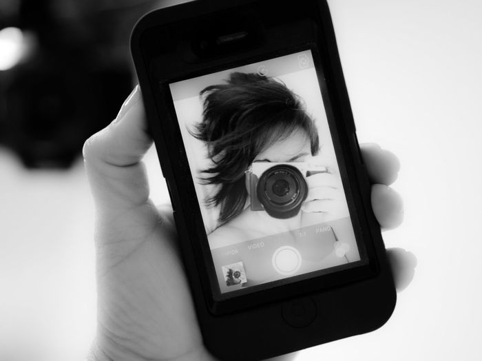 Close-up of woman photographing through camera