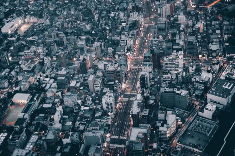 Aerial view of illuminated city against sky at night