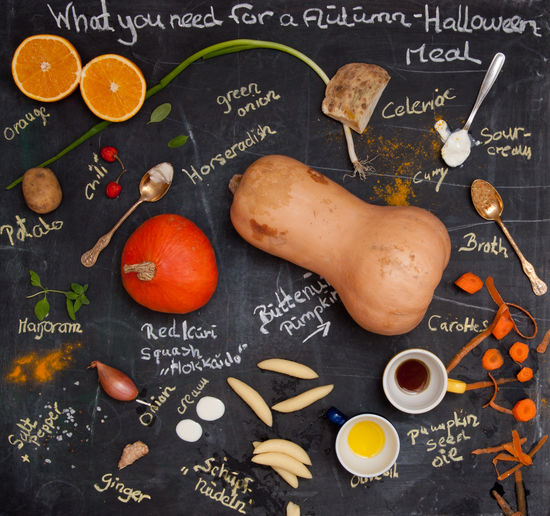 High angle view of pumpkin and pine nuts with text on table