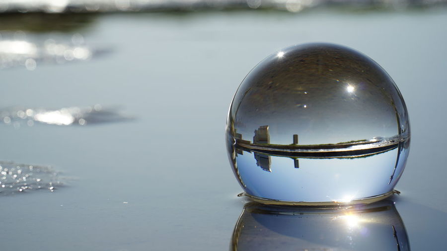 Close-up of crystal ball in sea