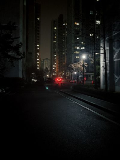 Illuminated city street and buildings at night