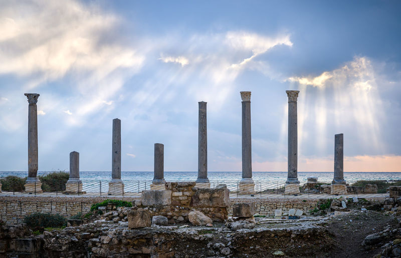 Ancient roman temple columns against mediterranean sea, in tyre-sour, lebanon, middle east