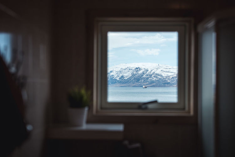 View through a house window of a boat in akureyri, iceland