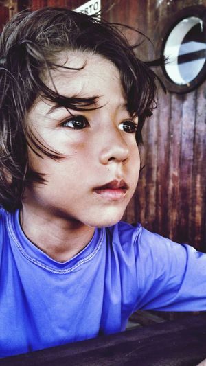 Close-up of boy sitting by table