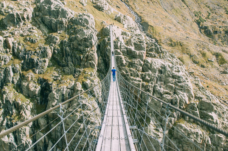 Rope bridge over rocks