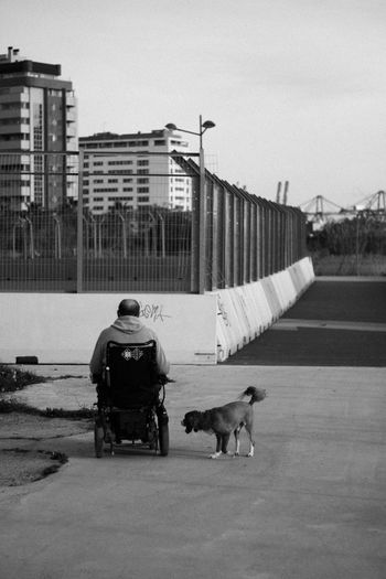 Side view of man with dog on street