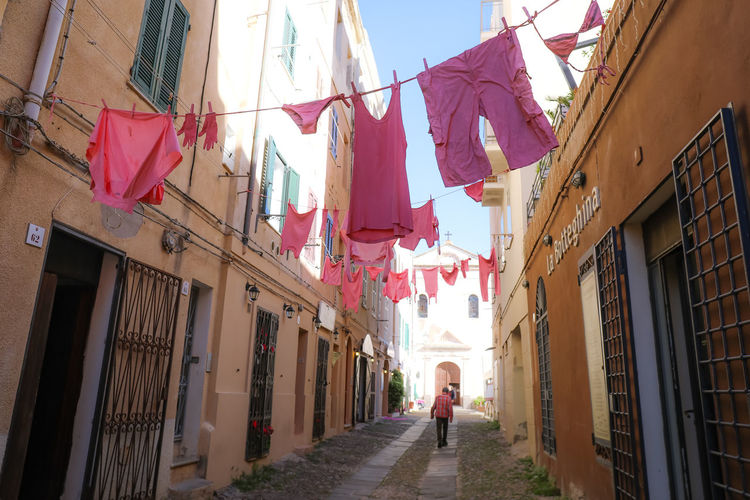 Laundry drying on ropes between buildings