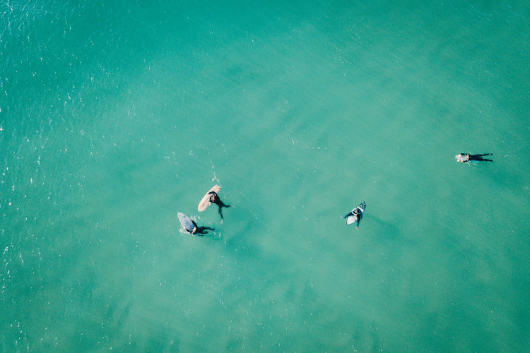 High angle view of people with surfboard in sea