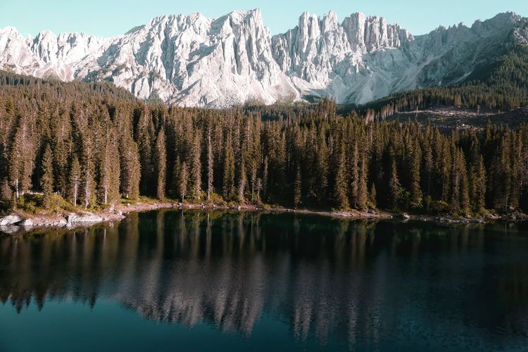 Scenic view of lake by snowcapped mountains during winter