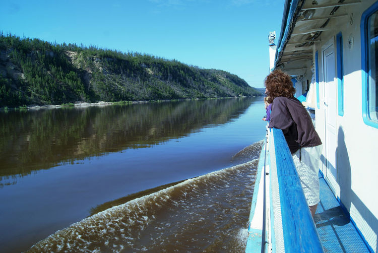 Woman standing on boat sailing at lena river