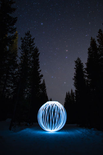 LIGHT PAINTING ON TREE AGAINST SKY