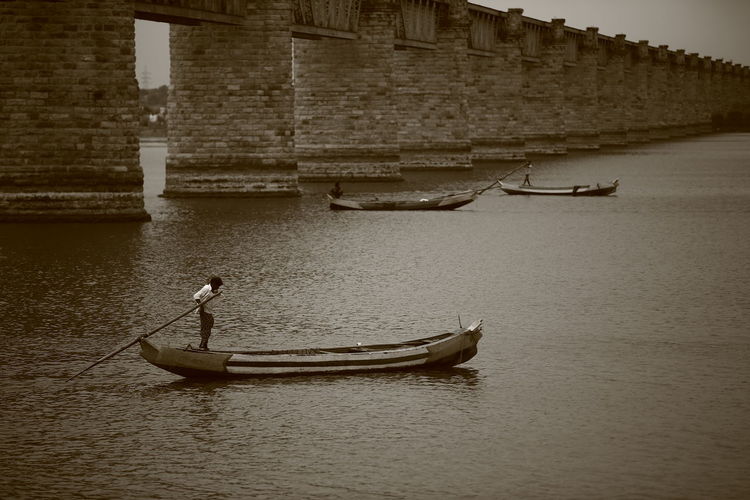 Man rowing boat in sea