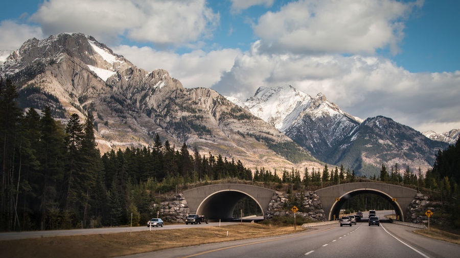 Road leading towards mountains against sky