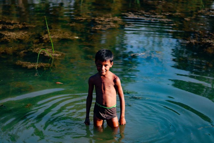 Smiling kid in bluewaters ..and his happiness