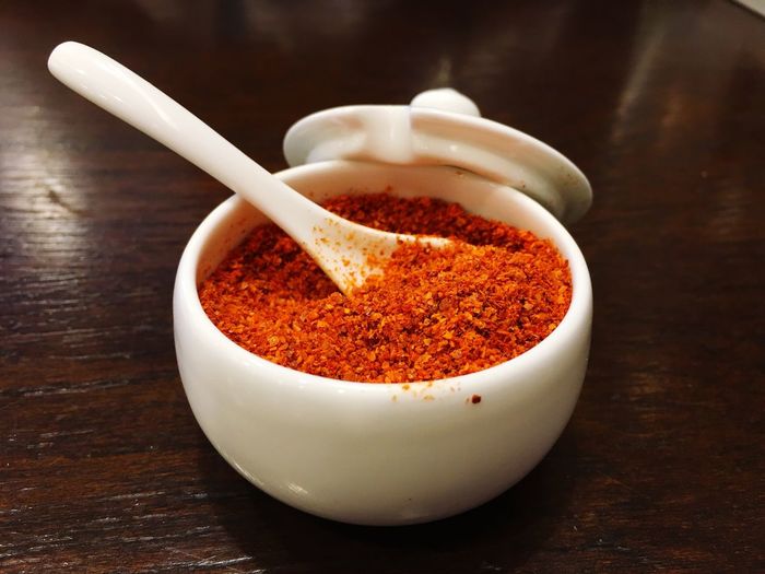 Close-up of red ground chili pepper in bowl
