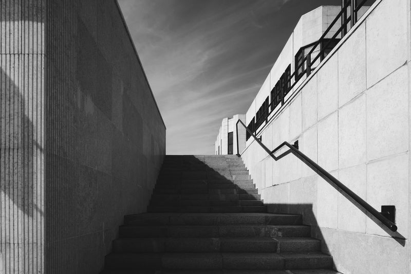Low angle view of staircase by building against sky