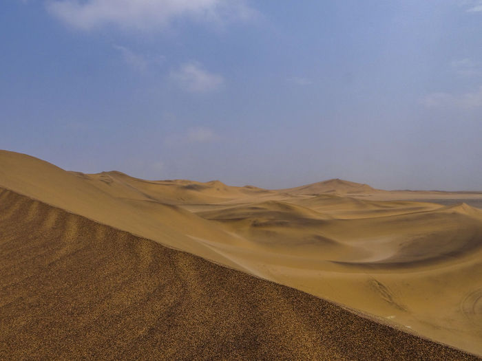 Photograph of a sand dune in the namib desert near swakopmund, namibia on a sunny dry season morning