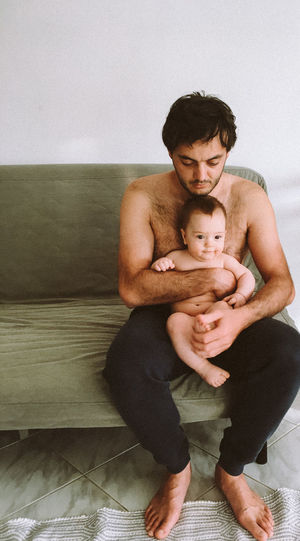 Portrait of father with baby sitting
