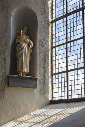 Statue in a church window with beautiful color changes
