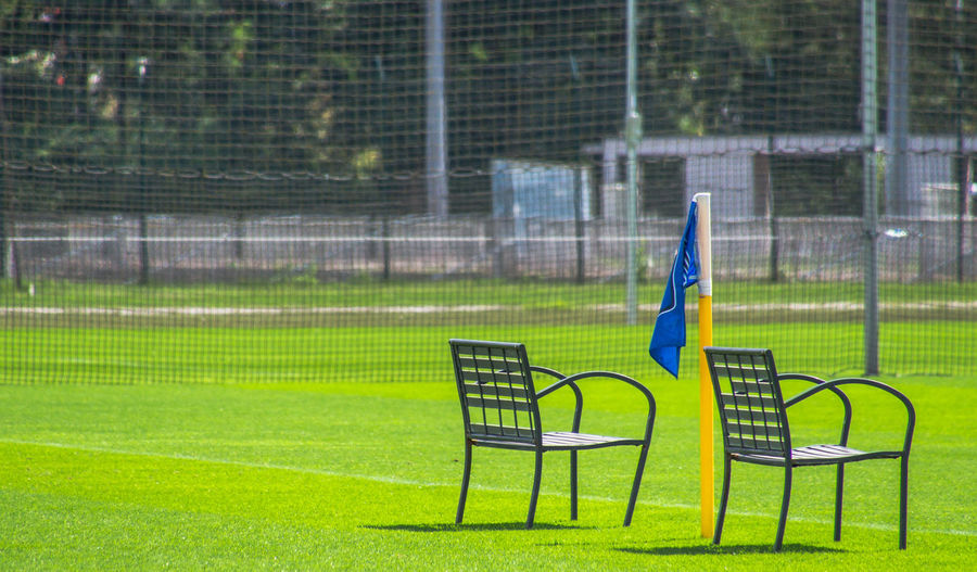 Empty chairs on soccer field